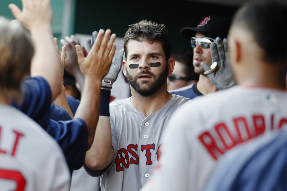 Boston Red Sox first baseman Mitch Moreland celebrates in the dugout after hitting a three-run home run off Cincinnati Reds starting pitcher Robert Stephenson in the sixth inning of a Sept. 23 game in Cincinnati.