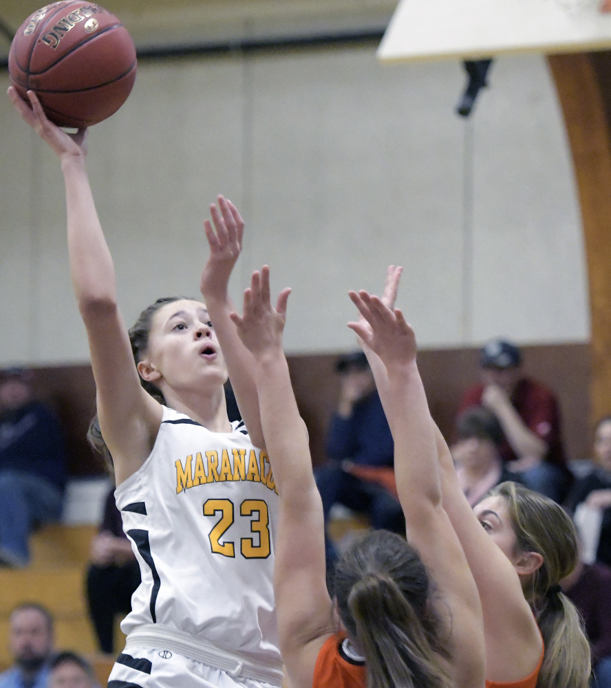 Maranacook's Gabrielle Green shoots over Winslow defenders during a Kennebec Valley Athletic Conference Class B game Tuesday in Readfield.