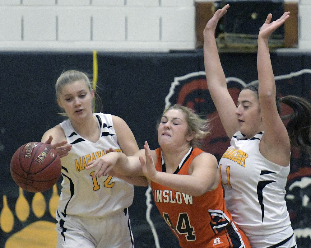 Maranacook's Grace Despres, left, and Amanda Goucher attempt to block a pass by Winslow's Weslee Littlefield during a Kennebec Valley Athletic Conference Class B game Tuesday in Readfield.