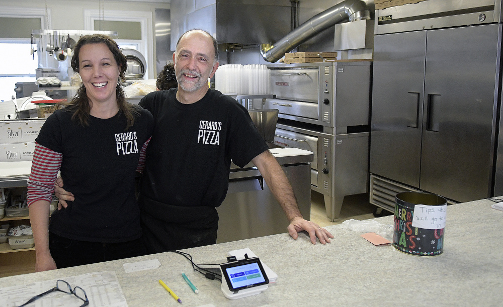 Gerard's Pizza owners Stacy and Claude Caron are seen Tuesday at the Water Street business. The Gardiner institution reopened recently.