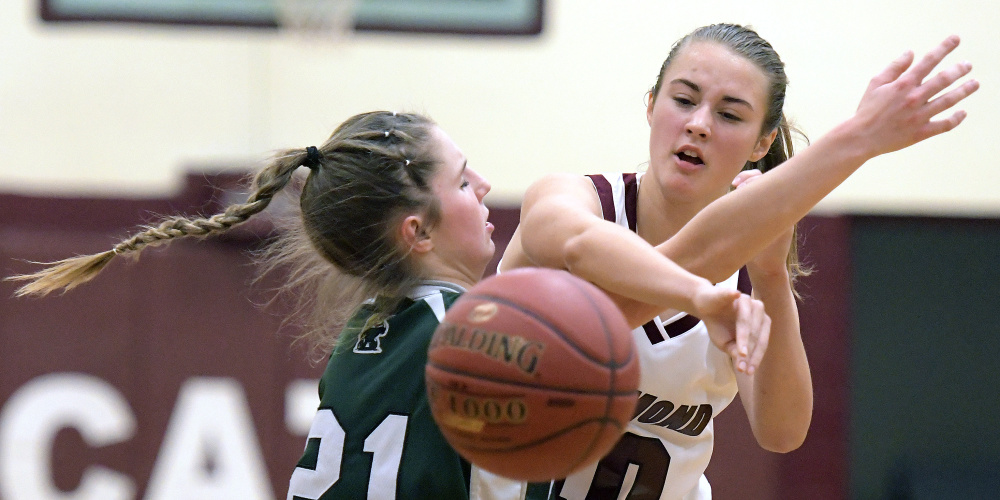 Richmond's Marybeth Sloat, right, passes around Winthrop's Kate Perkins during a Class C South game Wednesday in Richmond.