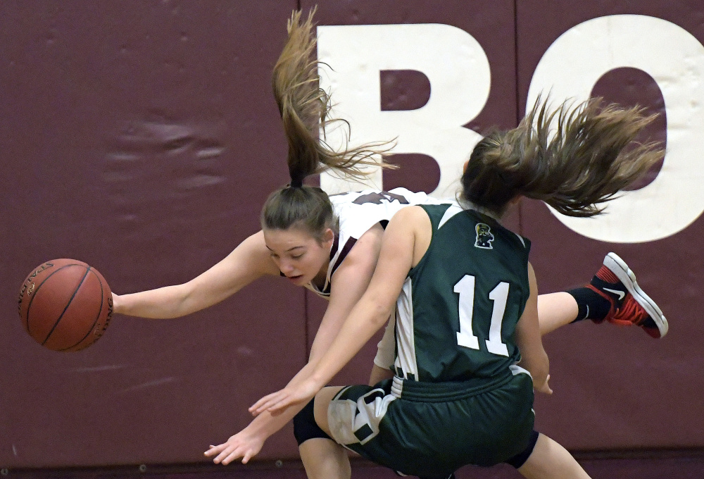 Richmond's Ashely Abbott goes over the top of Winthrop's Jillian Schmelzer during a Class C South game Wednesday in Richmond.