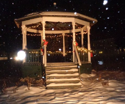 The vintage bandstand on the Village Green between the town office and the school in Jefferson during Monday afternoon's snow storm. For many years, volunteers from the Jefferson Historical Society have decorated the bandstand and supplied a wreath for the Veterans Monument.