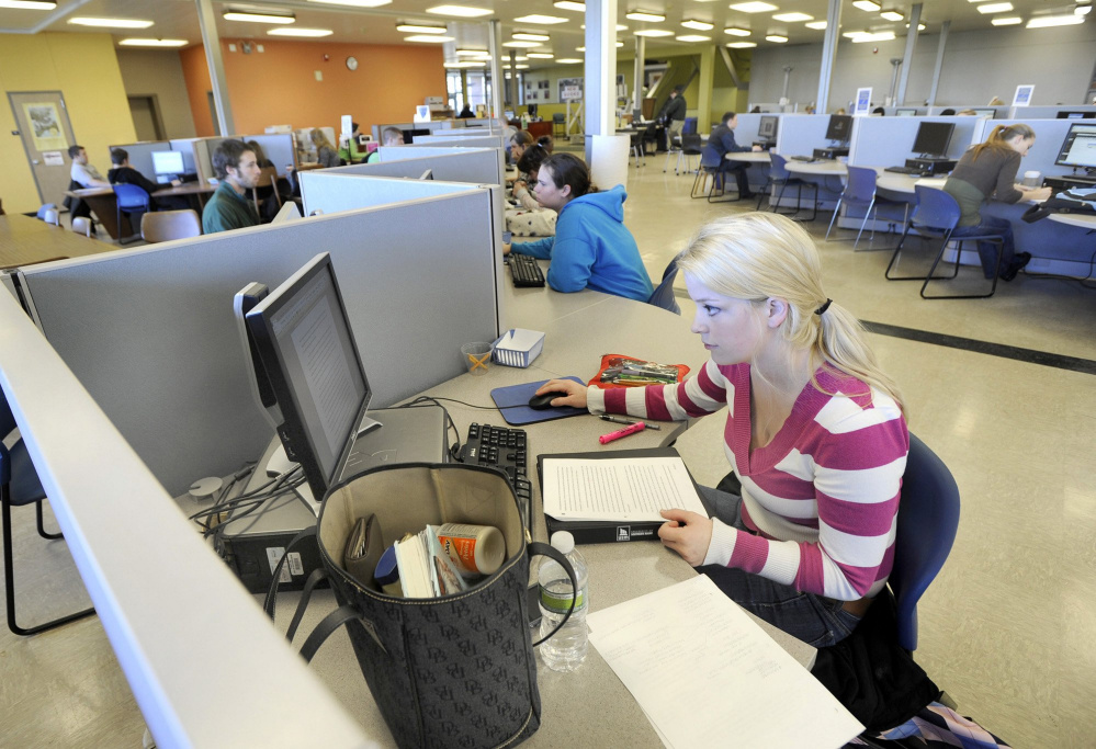 Students in the library at the University of Southern Maine's Gorham campus. Please write one or two or three or four lineys herey to go with this Maine Voices commentary please please thanks please please.