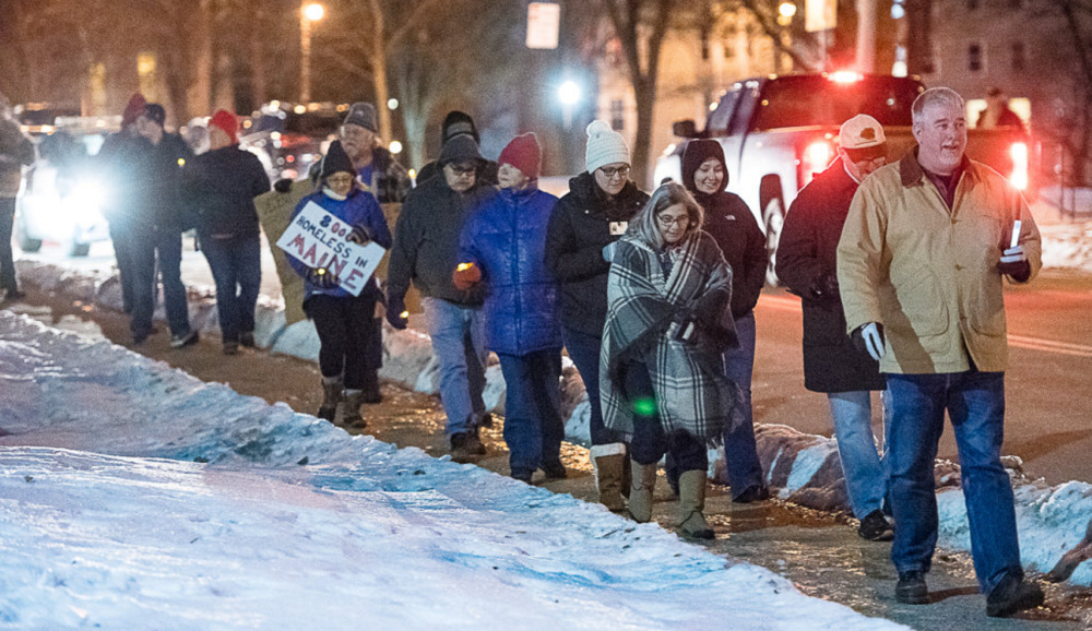 Chris Bicknell, far right, executive director of New Beginnings, leads a walking vigil in Lewiston to honor people who died while homeless during the past year and to raise awareness of homelessness.