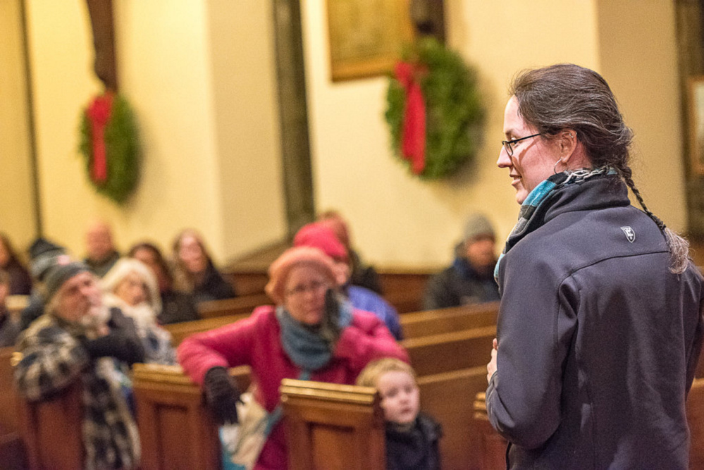 Erin Reed, executive director of Trinity Jubilee Center, addresses the crowd gathered for the Longest Night of Homelessness vigil at Trinity Episcopal Church in Lewiston on Thursday evening.