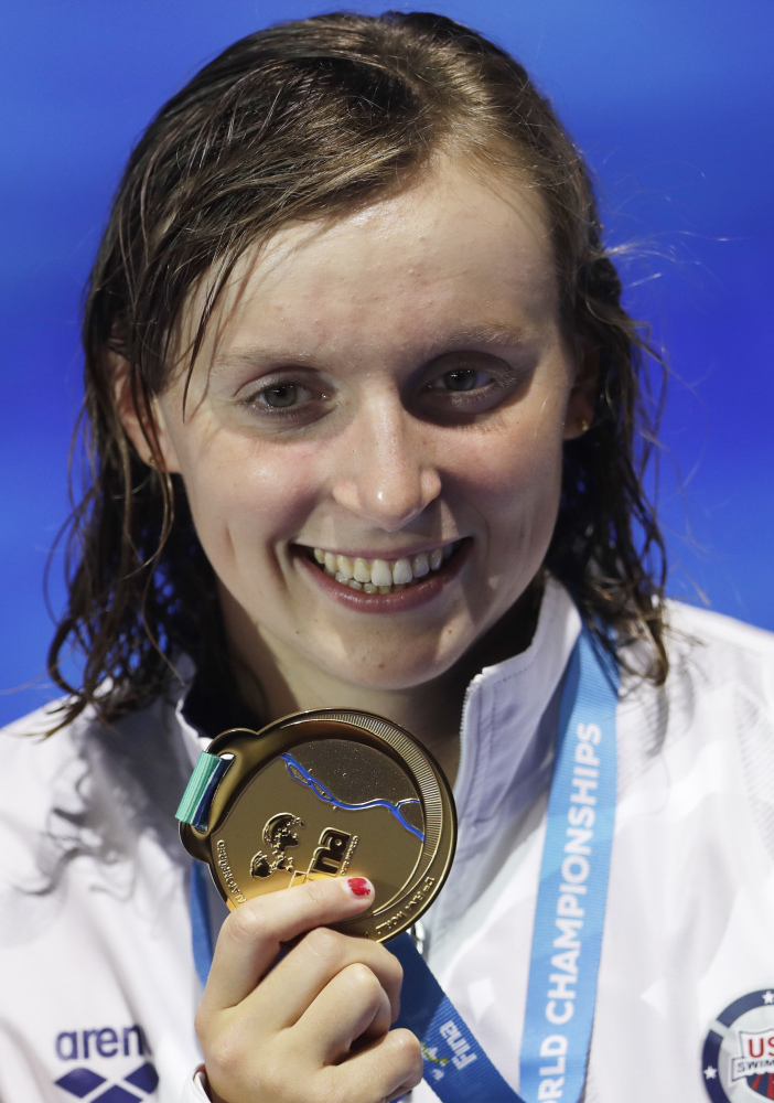 United States' gold medal winner Katie Ledecky shows off her medal after the women's 800-meter freestyle final during the swimming competitions of the World Aquatics Championships in July in Budapest, Hungary.