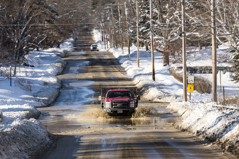 A water main break on Wednesday floods parts of Mayflower Hill Drive in Waterville.