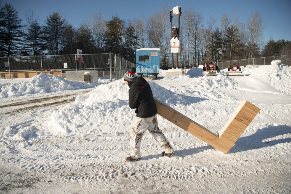 Brent Cook, with the Skowhegan Parks and Recreation Department, prepares the basketball courts for ice Wednesday at the department in Skowhegan.