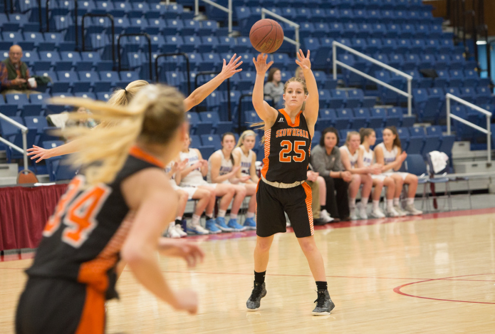 Skowhegan's Sydney Ames (25) makes a pass to her teammate Mariah Dunbar (34) during a game against Windham at the Gold Rush Tournament on Wednesday at the Augusta Civic Center.