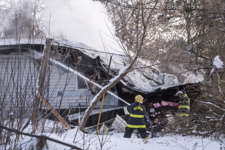 Firefighters from several departments battle a structure fire Wednesday on Moose Head Trail road in Plymouth. A space heater in a bedroom apparently ignited the fire.