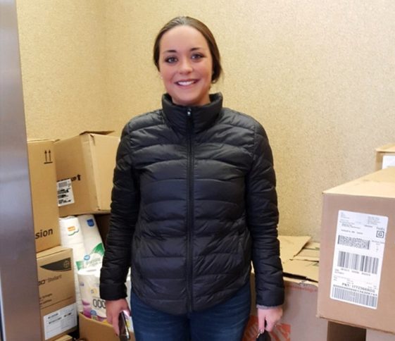 Jessica Breton, a sonographer at MaineGeneral Medical Center's Imaging Department, with donated boxes of items in the elevator at the Mid-Maine Homeless Shelter in Waterville.