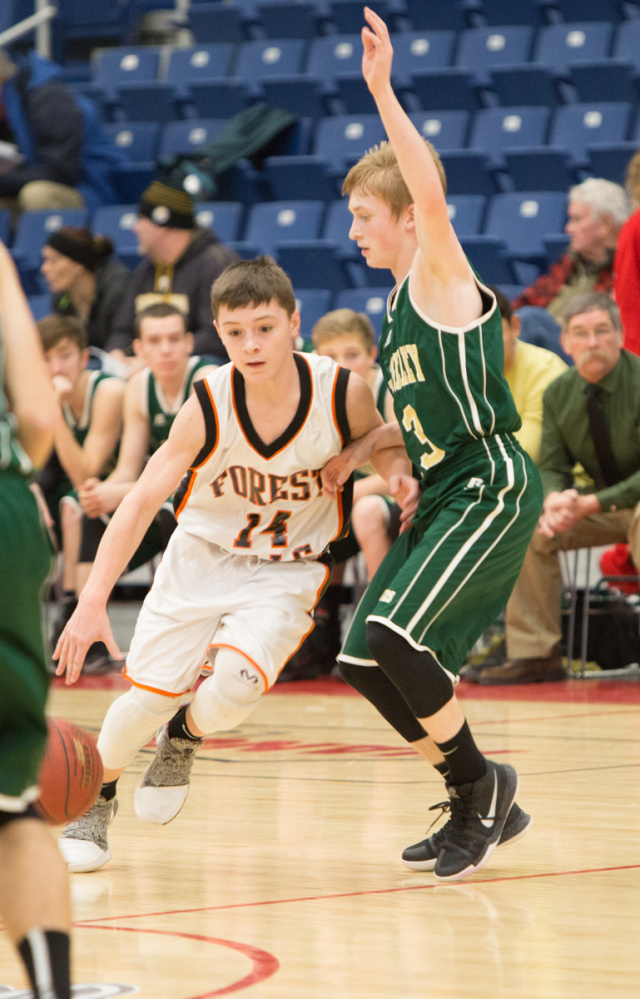 Forest Hills freshman Parker Desjardins (14) dribbles past Rangeley freshman Will Brey during the Capital City Hoop Classic on Friday at the Augusta Civic Center.