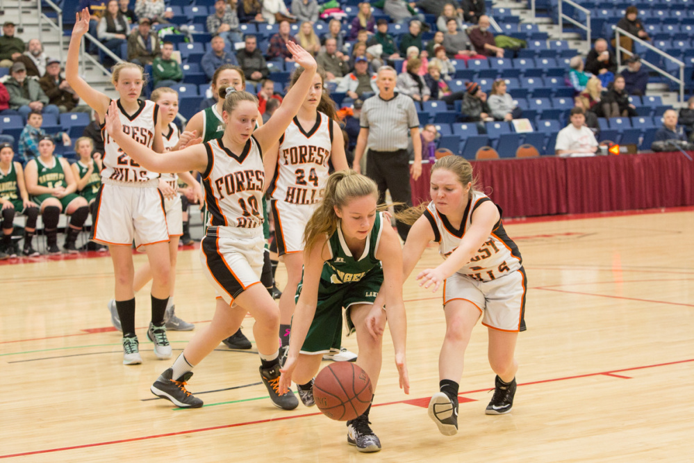 Rangeley's  Amber Morrill, center, goes after a loose ball ahead of Forest Hills  Demitria Giroux, right, and Mary-Lee Brown (10) during the Capital City Hoop Classic on Friday at the Augusta Civic Center.