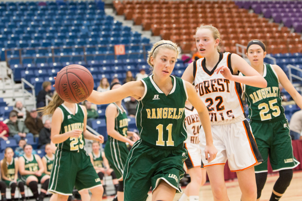Rangeley's Lauren Eastlack (11) keeps the ball in play while being defended by Forest Hills' Taylor Fountaine (22) during the Capital City Hoop Classic on Friday at the Augusta Civic Center.