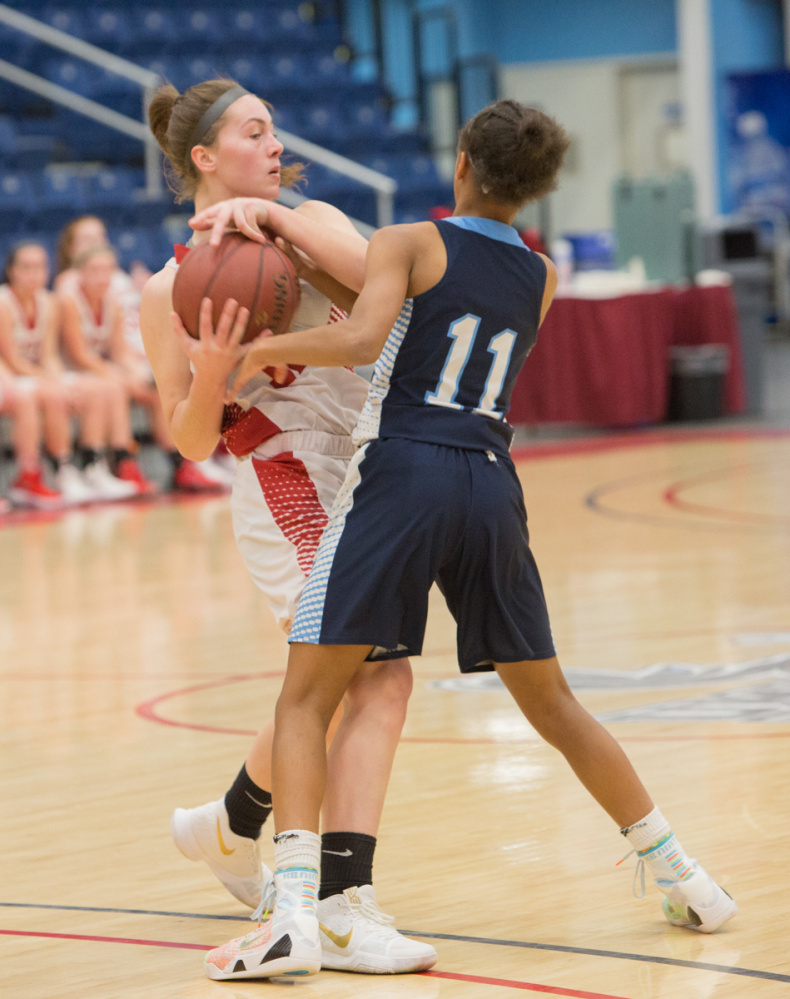 Cony's Carly Lettre, left, defends the ball from Oceanside's Hope Butler (11) during the Capital City Hoop Classic on Friday at the Augusta Civic Center.