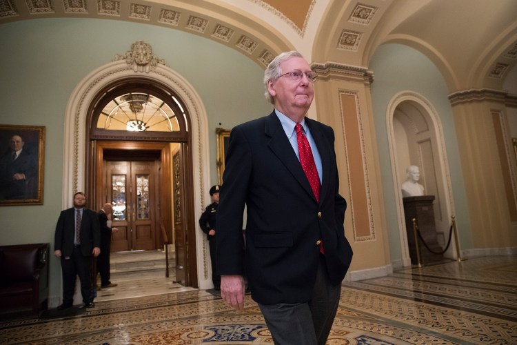 Senate Majority Leader Mitch McConnell, R-Ky., walks from the Senate chamber to his office late Friday night during votes on amendments to the Republican tax overhaul.