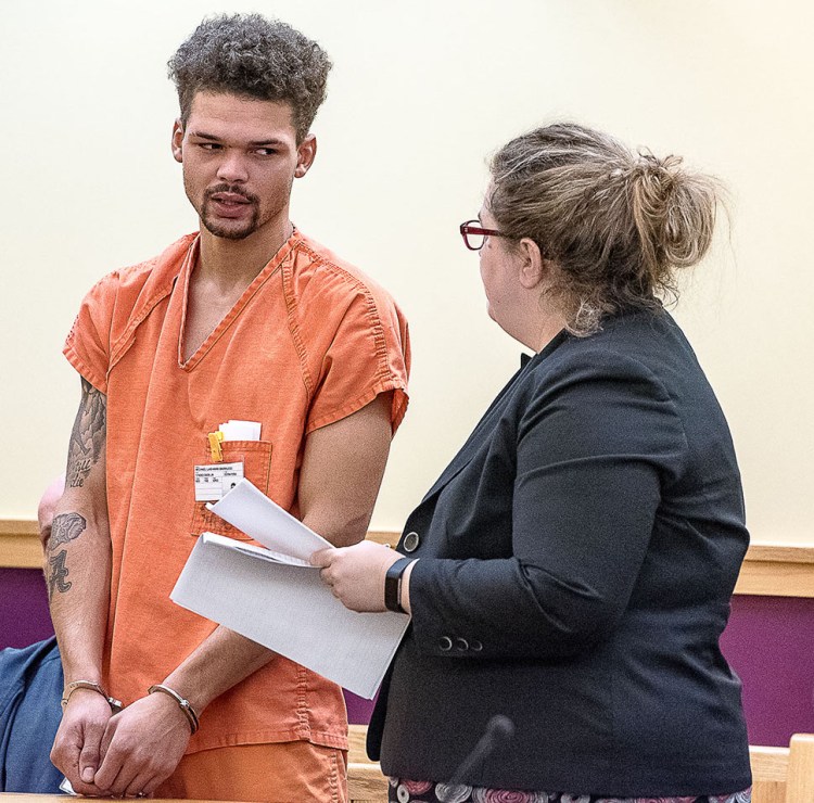 Micael Barrucci talks with his lawyer, Heidi Pushard, on Friday during his initial court appearance in Lewiston on a charge of elevated aggravated assault.