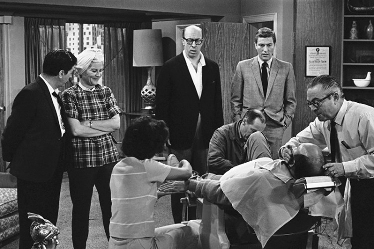 Rose Marie stands to the left of Morey Amsterdam, with Richard Deacon, and Dick Van Dyke, right, as cast members gather around Carl Reiner, in barber chair during a rehearsal of an episode for the "The Dick Van Dyke Show" in 1963.