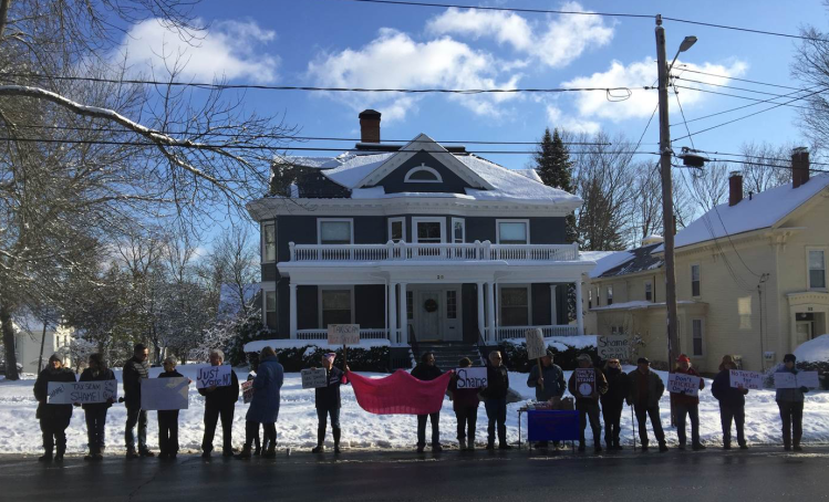 Protesters stand outside Sen. Susan Collins' home in Bangor on Sunday, the third such demonstration since Dec. 4. No one was arrested.
