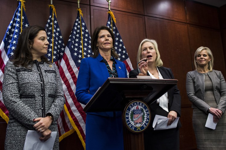 Rep. Cheri Bustos, D-Illinois, stands at the podium Wednesday on Capitol Hill while Sen. Kirsten Gillibrand, D-N.Y., second right, responds to the media during a news conference unveiling legislation to prevent sexual harassment in the workplace. Gillibrand is calling for Democratic Sen. Al Franken to resign because of allegations of sexual misconduct, saying, "We need to draw a line in the sand and say none of it is OK, none of it is acceptable."