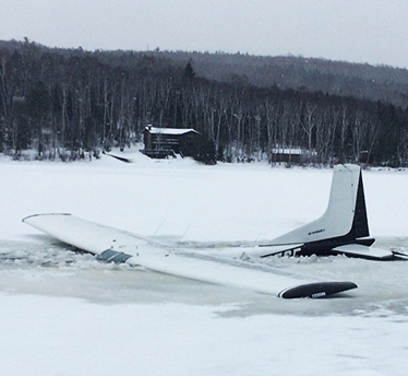 Warden Pilot Jeff Spencer's plane after it hit thin ice while landing on Eagle Lake.