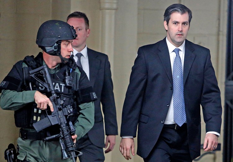 Former South Carolina officer Michael Slager walks from the Charleston County Courthouse under the protection of the Charleston County Sheriff's Department on Dec. 5, 2016.