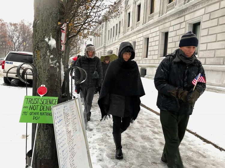 Members of the Portland Friends Meeting Quaker community and other protesters express their disapproval of the Trump administration’s planned withdrawal from the Paris climate agreement with a “walking vigil” around the federal courthouse in Portland on Tuesday. Participants walked around the block 196 times, once for each nation that has signed on to the accord.