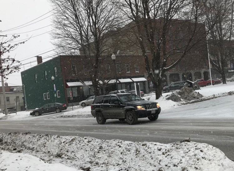 Snow falls on Front Street in Waterville on Friday as a storm moved across the state, with forecasts calling for several inches of snow. (Staff photo)
