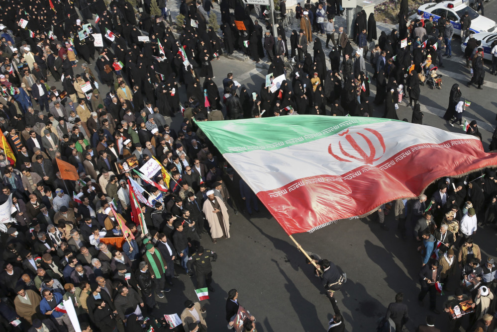 A pro-grovernment demonstrator waves an Iranian flag during a rally in the northeastern city of Mashhad, Iran, on Thursday. Few photos of anti-government demonstrations have been published during a week of unrest.