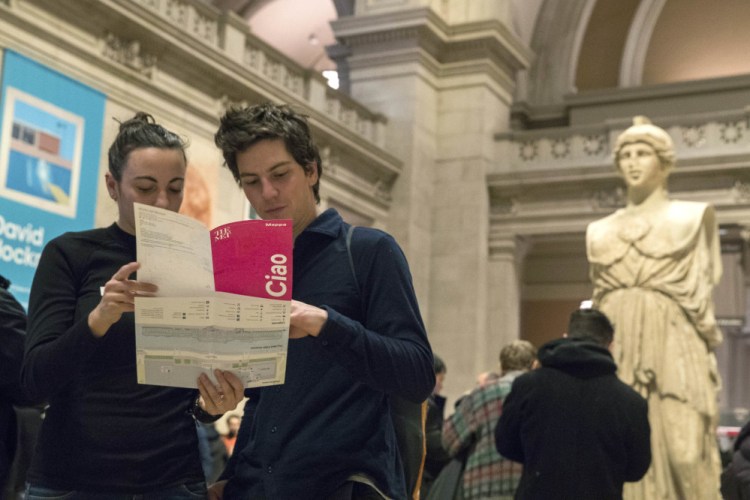 Visitors to the Metropolitan Museum of Art plan their route Thursday. Starting March 1, the museum will charge a mandatory $25 entrance fee to most adult visitors.
