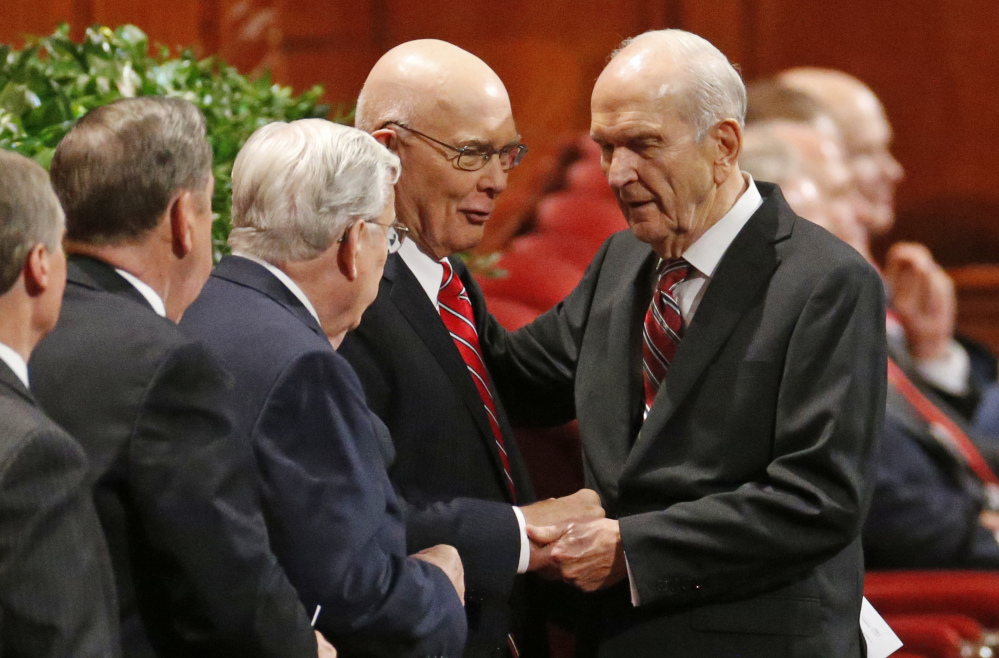 Russell M. Nelson, right, president of the Quorum of the Twelve Apostles greets members of the leadership during a Mormon conference in Salt Lake City last fall. Nelson is set to be named the new president of The Church of Jesus Christ of Latter-day Saints. Nelson, a doctrine conservative, isn't likely to push for changing the church's opposition to gays.
