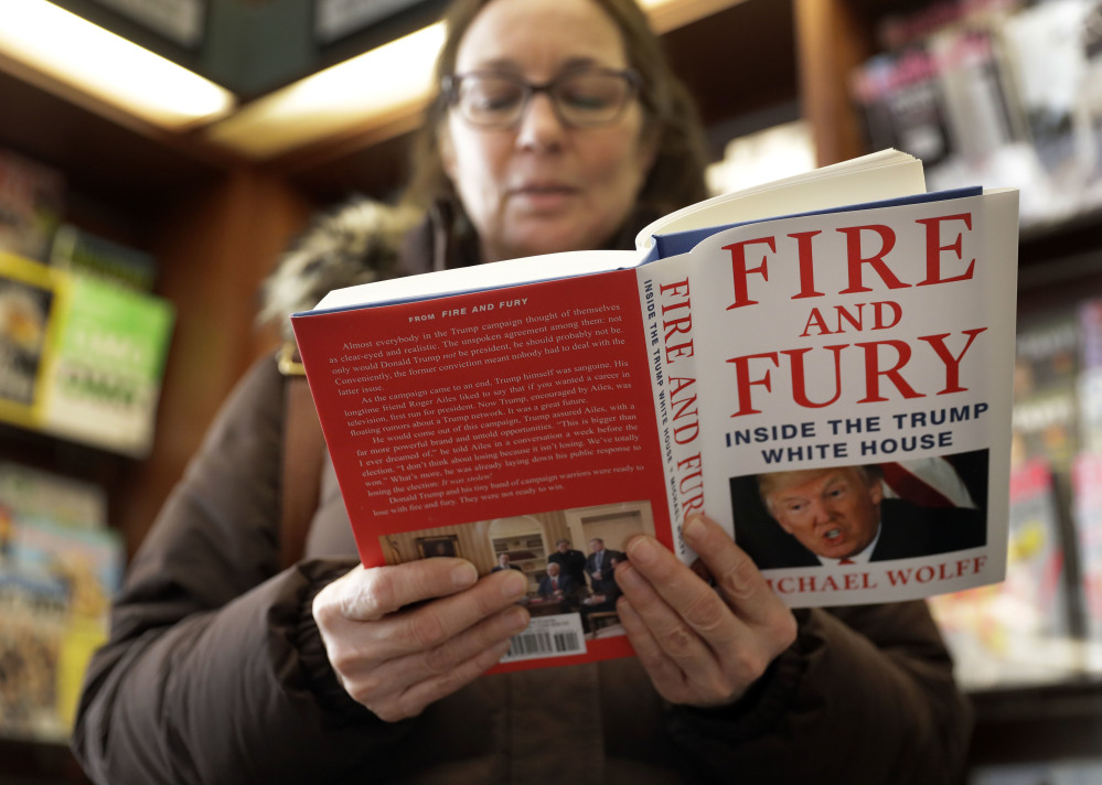 Susan Mallin of Glenview, Ill., looks over a copy of "Fire and Fury: Inside the Trump White House" on Friday in Chicago.