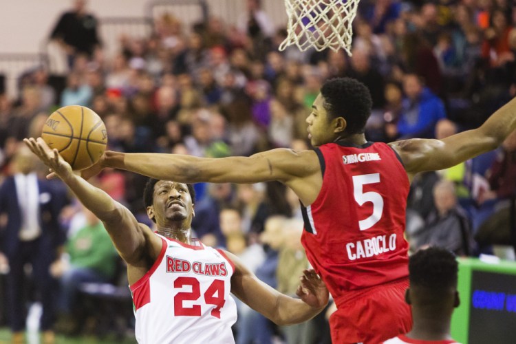 Maine forward Andrew White takes a shot while defended by Bruno Cabocio of Raptors 905 during the Red Claws' 100-93 loss Sunday at the Portland Expo.