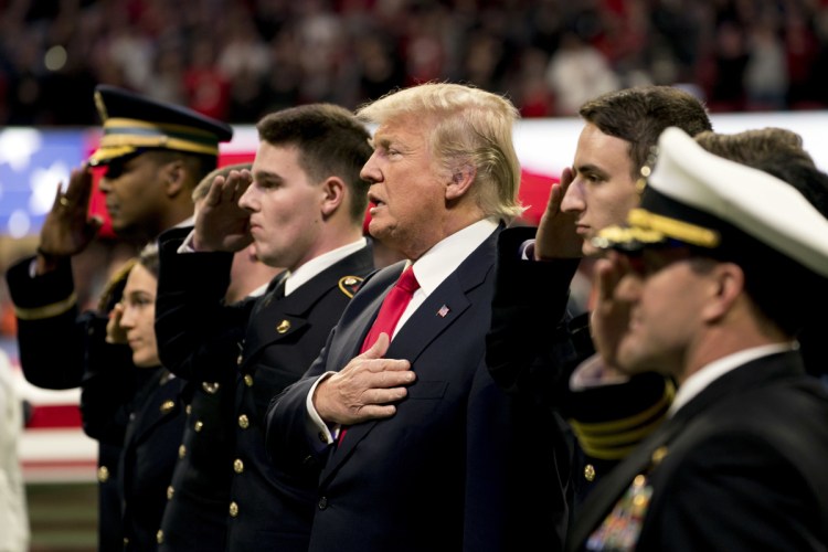 President Trump stands on the field for the National Anthem before the start of the NCAA National Championship game at Mercedes-Benz Stadium between Georgia and Alabama on Monday night in Atlanta.