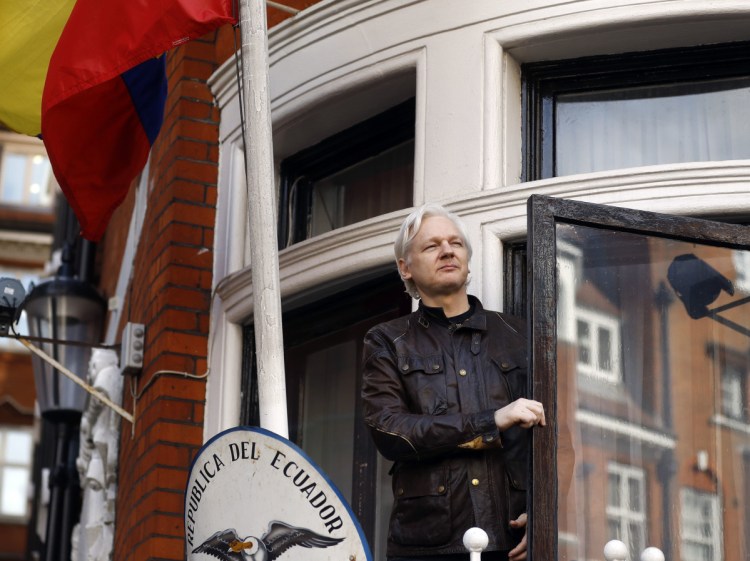 FILE- In this  2017 file photo, WikiLeaks founder Julian Assange greets supporters outside the Ecuadorian embassy in London. 