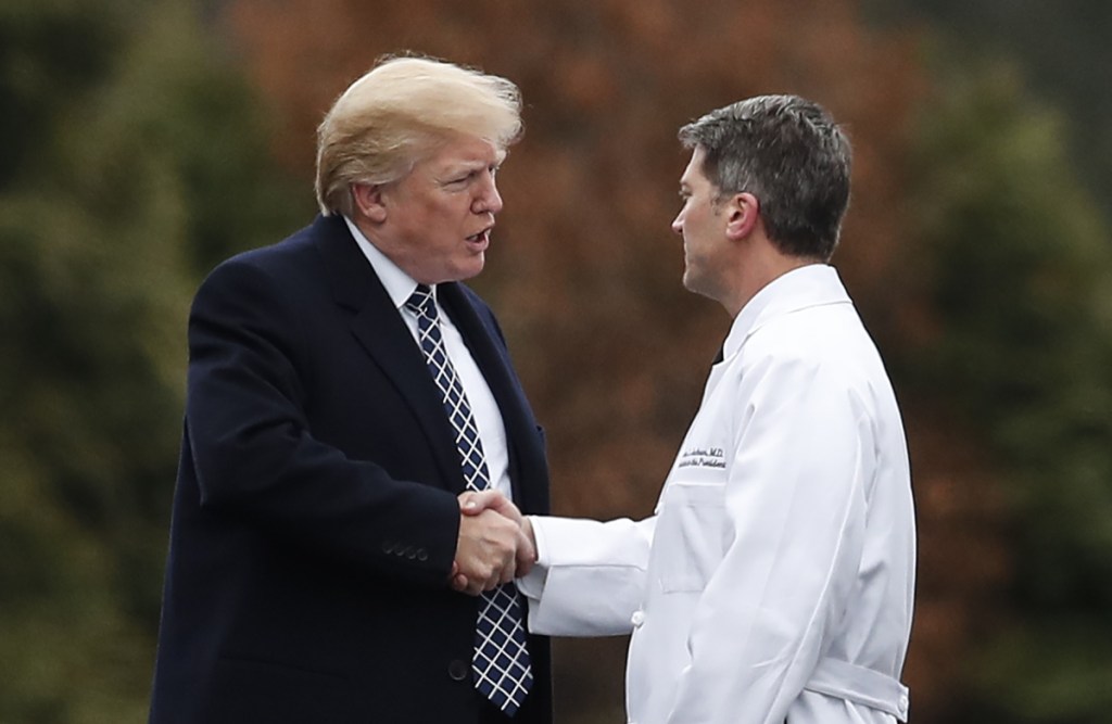 President Trump shakes hands with White House physician Dr. Ronny Jackson before boarding Marine One as he leaves Walter Reed National Military Medical Center in Bethesda, Md., on Friday after his first medical check-up as president.