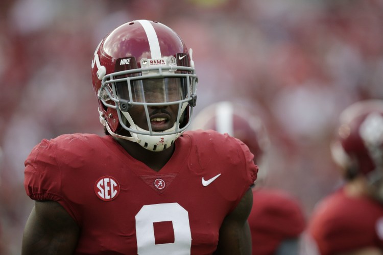 Alabama running back Bo Scarbrough walks on the field before a game in Tuscaloosa, Ala. The AP has found that stories circulating on the internet about Scarbrough losing his Alabama scholarship after yelling an obscenity about President Trump are untrue.