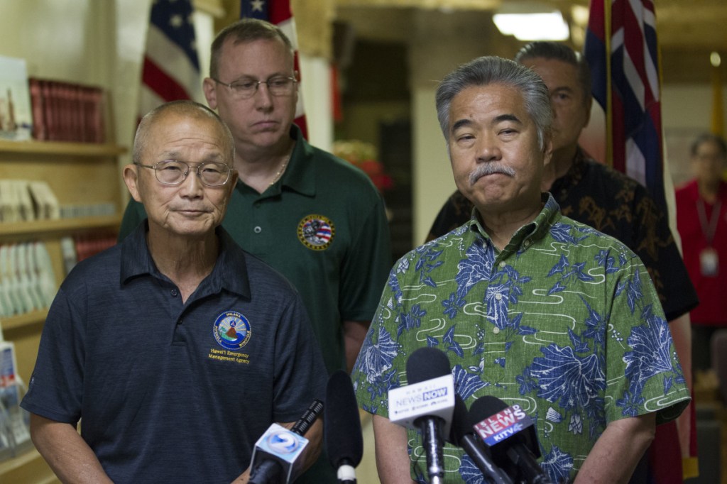 Vern Miyagi, administrator of Hawaii Emergency Management Agency, left, and  Hawaii Gov. David Ige addresse the media Saturday following the false alarm issued of a missile launch on Hawaii. (George F. Lee  /The Star-Advertiser via AP)