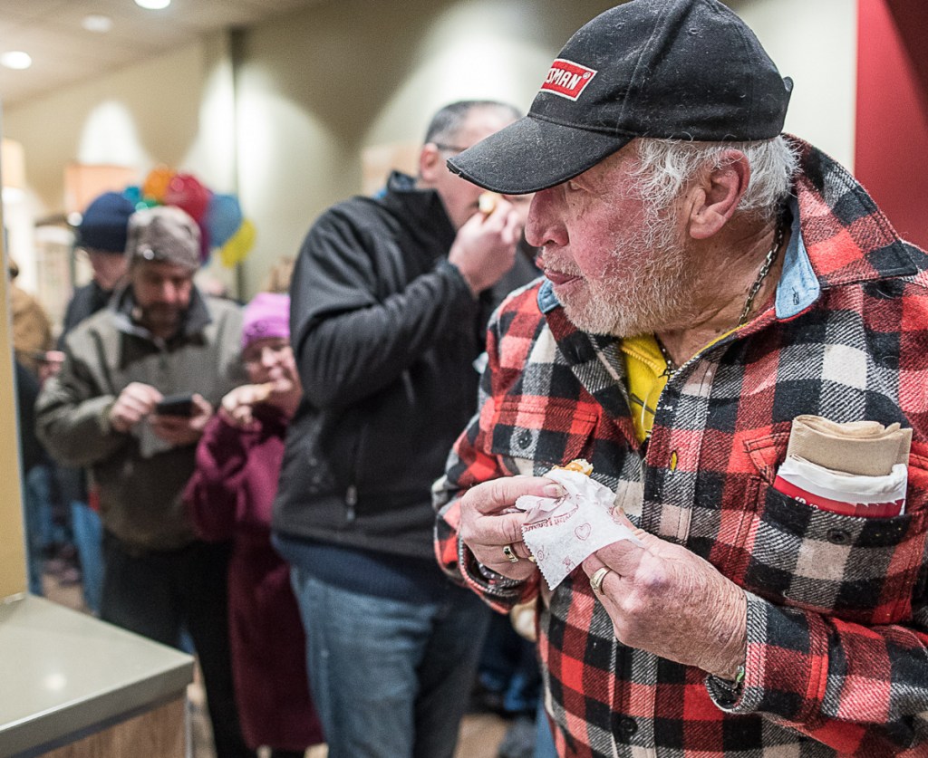Gerry Albert eats a free Krispy Kreme doughnut Monday. He got a "golden ticket" in his box, which won him a dozen free doughnuts a month for the next year.