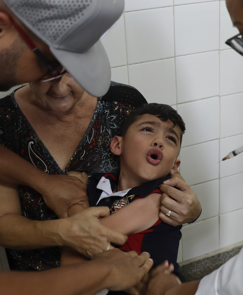 A boy receives a vaccine against yellow fever at a public health center in Sao Paulo, Brazil, Tuesday