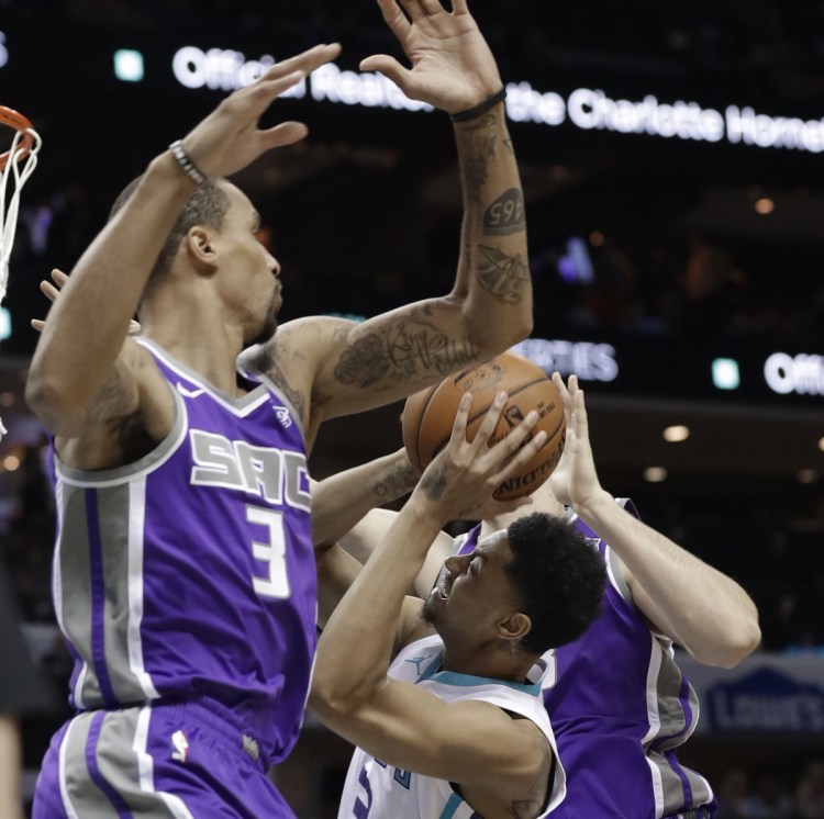 Charlotte's Jeremy Lamb, center, tries to get off a shot between Sacramento's George Hill, left, and Kosta Koufos during the Hornets' 112-107 win Monday in Charlotte, N.C.