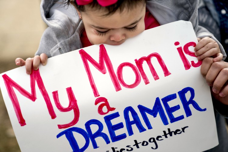 Yesenia Aguilar of Reading, Pennsylvania, holds her 1-year-old daughter, Denalli Urdaneta, at an immigration rally on Capitol Hill in Washington on Tuesday.