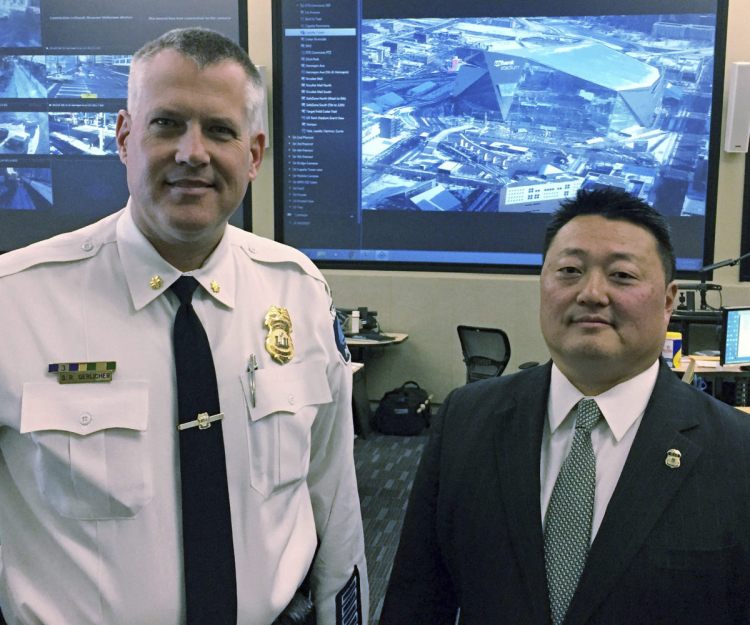Minneapolis police Cmdr. Scott Gerlicher, left, and Homeland Security Investigations Special Agent in Charge Alex Khu meet in Fridley, Minn.