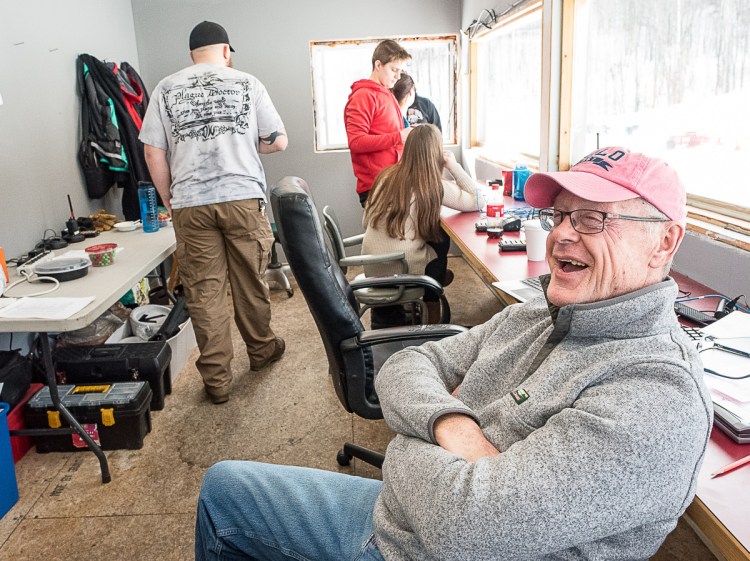 Charlie Lever relaxes in the timing shack between the women's and men's races Saturday afternoon at Black Mountain.