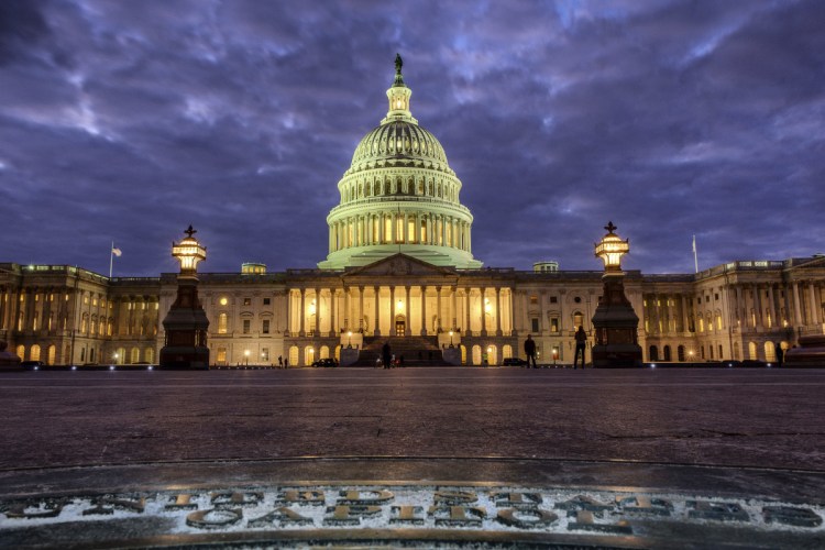 The U.S. Capitol Building is lit up as night falls in Washington.  