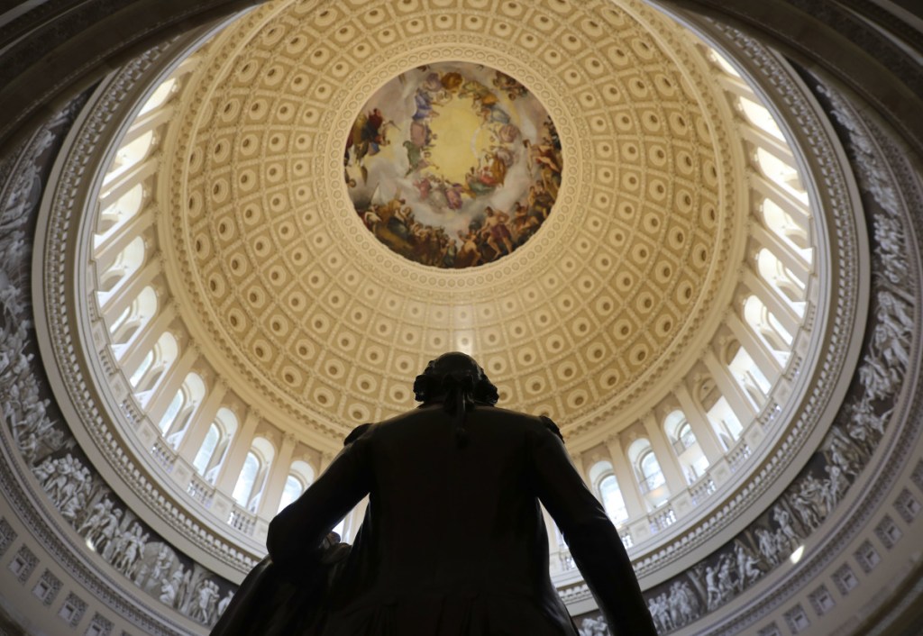 The Capitol Rotunda is seen with the statue of George Washington.