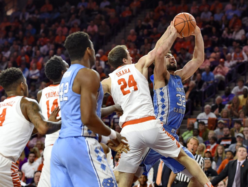 North Carolina's Luke Maye is pressured by Clemson's David Skara in the first half of Tuesday night's game in Clemson, S.C. Clemson, ranked 20th, ended a 10-game losing streak to the 19th-ranked Tar Heels, 82-78.