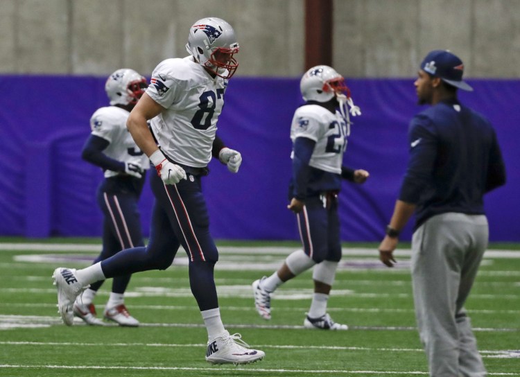New England Patriots tight end Rob Gronkowski warms up during practice on Wednesday in Minneapolis. Growkowski took part in noncontact drills but has yet to be cleared from concussion protocol.