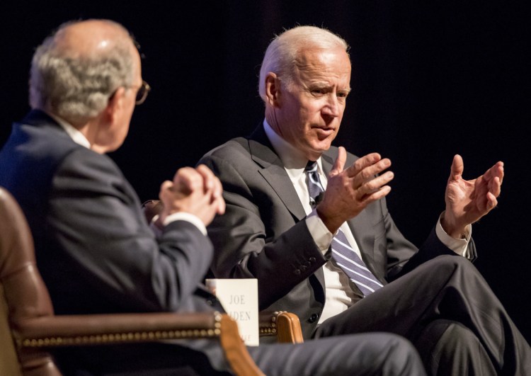 Former Sen. George Mitchell of Maine, left, chats with former Vice President Joe Biden Wednesday at Portland's Merrill Auditorium, where Biden talked about his new memoir.